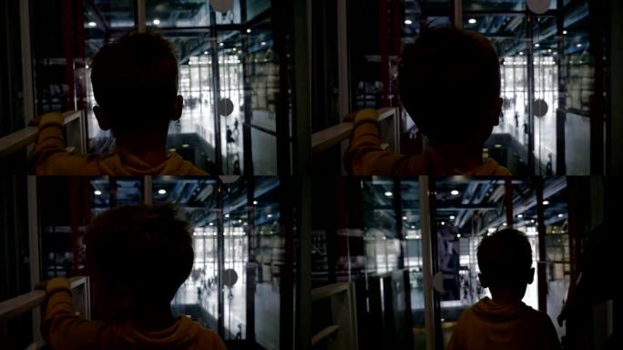 儿童乘坐现代玻璃电梯