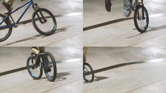 MTB自行车骑手在滑板场骑行时会进行各种技巧。极限运动，骑手在晚上做桌面尾鞭把戏