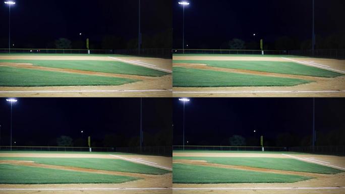 空旷的棒球场晚上射击。天空中的一些闪电。