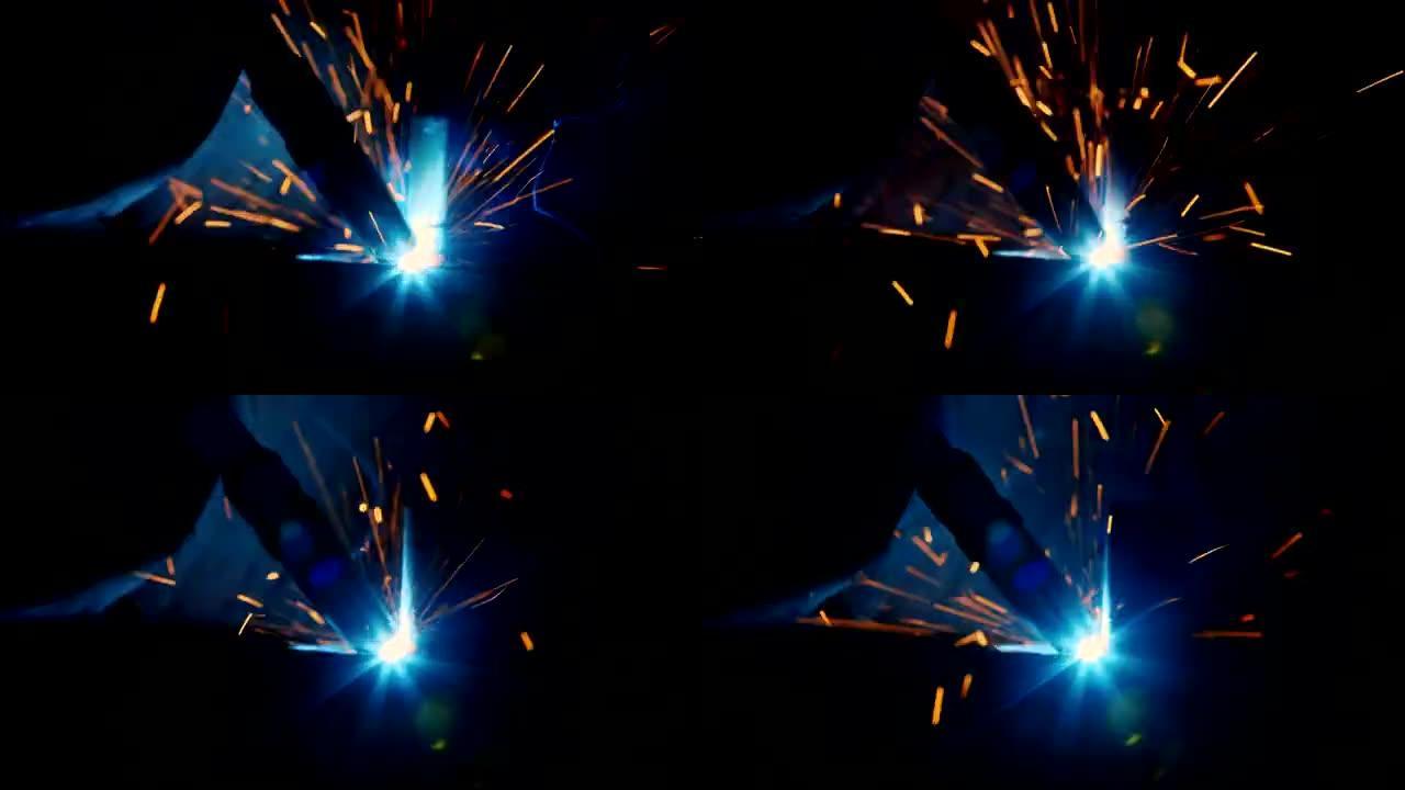 熔融蒸汽的火花和明亮的电焊光。电弧下的流星细节特写
