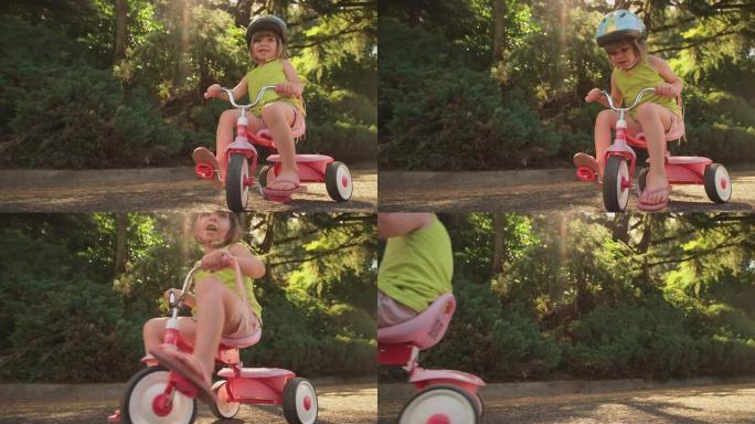 一个可爱的小女孩坐在她的三轮车上，微笑着，然后骑车离开