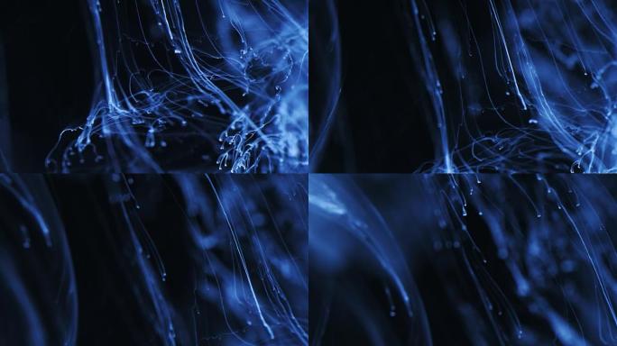 墨水移动。浅蓝色粒子墨水的宇宙抽象。宏
