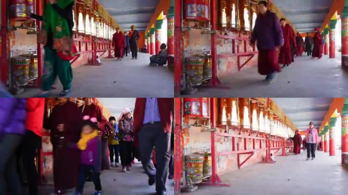 喇嘛和尼姑在拉容伽(拉容五科佛学院)的转经轮上散步。这是中国四川色达著名的喇嘛庙。