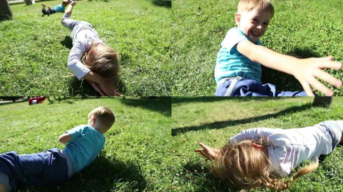 草地上的女孩和男孩翻筋斗