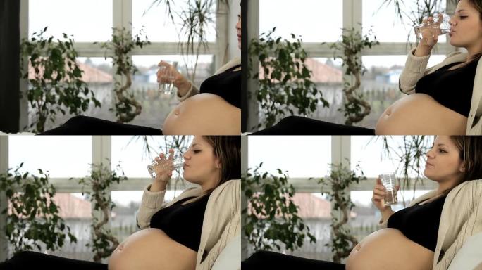 怀孕饮用水中的年轻美女