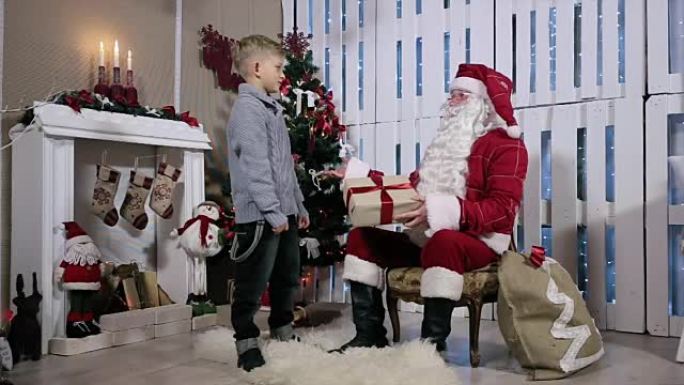 男孩是灰色盒子礼物圣诞老人，摇了摇耳朵
