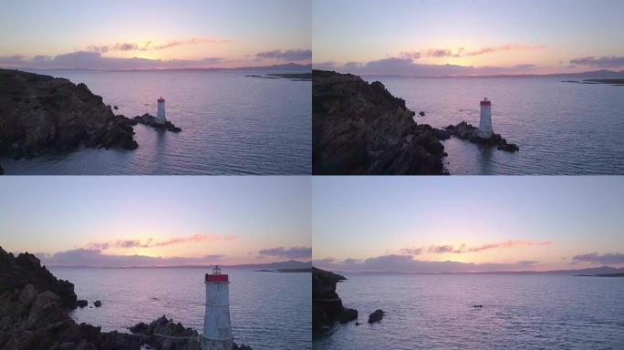 日落时灯塔的无人机拍摄的空中视频。意大利撒丁岛翡翠海岸。