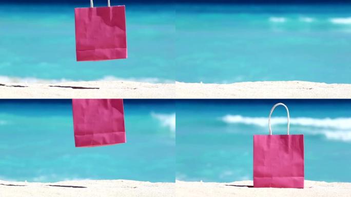 女人拿着粉红色的购物袋，放在沙滩上，抵御碧绿的加勒比海海水