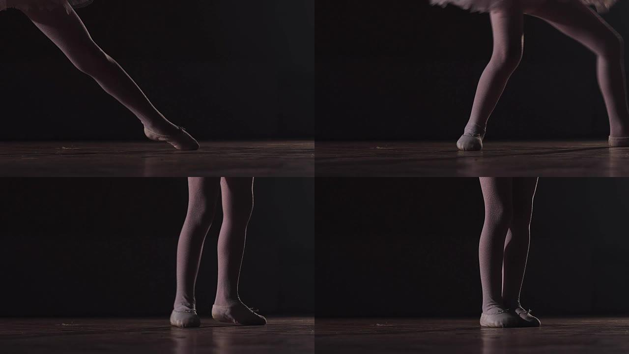 在黑暗的工作室里练习芭蕾舞演员的脚的特写镜头