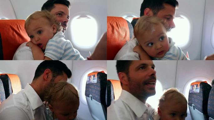 父亲把婴儿抱在飞机上。等待飞机起飞的乘客。爸爸带着婴儿乘飞机旅行