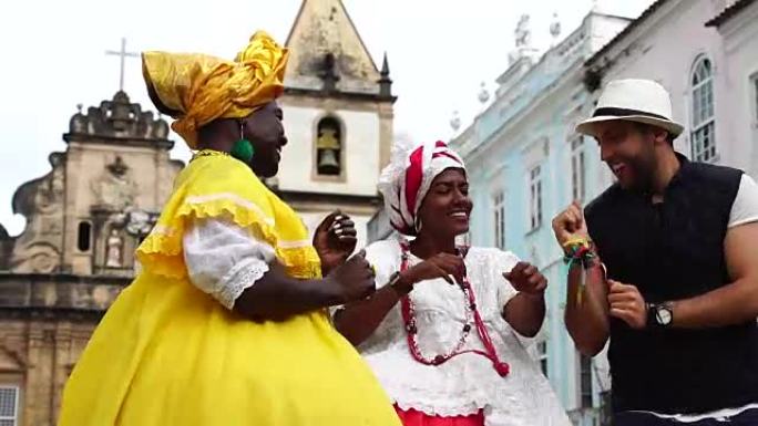 游客为巴西土著妇女跳舞并戴上帽子-“Baiana”