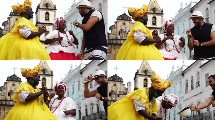游客为巴西土著妇女跳舞并戴上帽子-“Baiana”