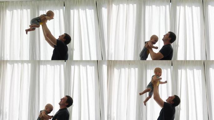 年轻的父亲带着他的小婴儿玩耍