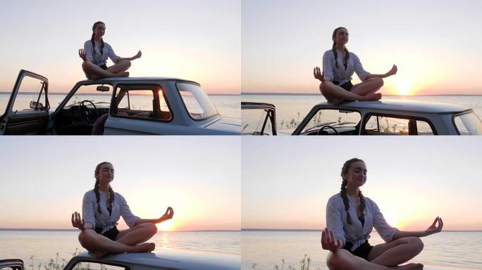 女孩在户外屋顶汽车上冥想，女性在背景大海的背景下在日落时冥想，快乐的旅程