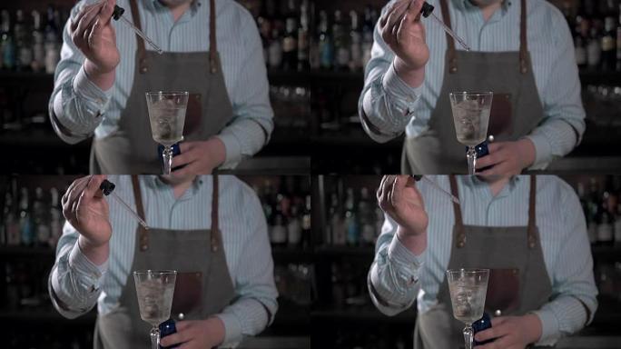 餐厅酒吧调酒师服务台的年轻酒保工人准备从移液器滴落的鸡尾酒