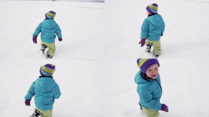 慢动作: 小男孩在积雪覆盖的田野上奔跑