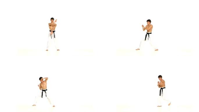 男子训练跆拳道或空手道孤立在白色上