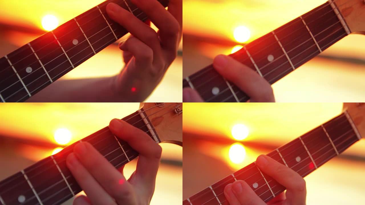 男子特写电吉他在日落和在阳光下玩岩石