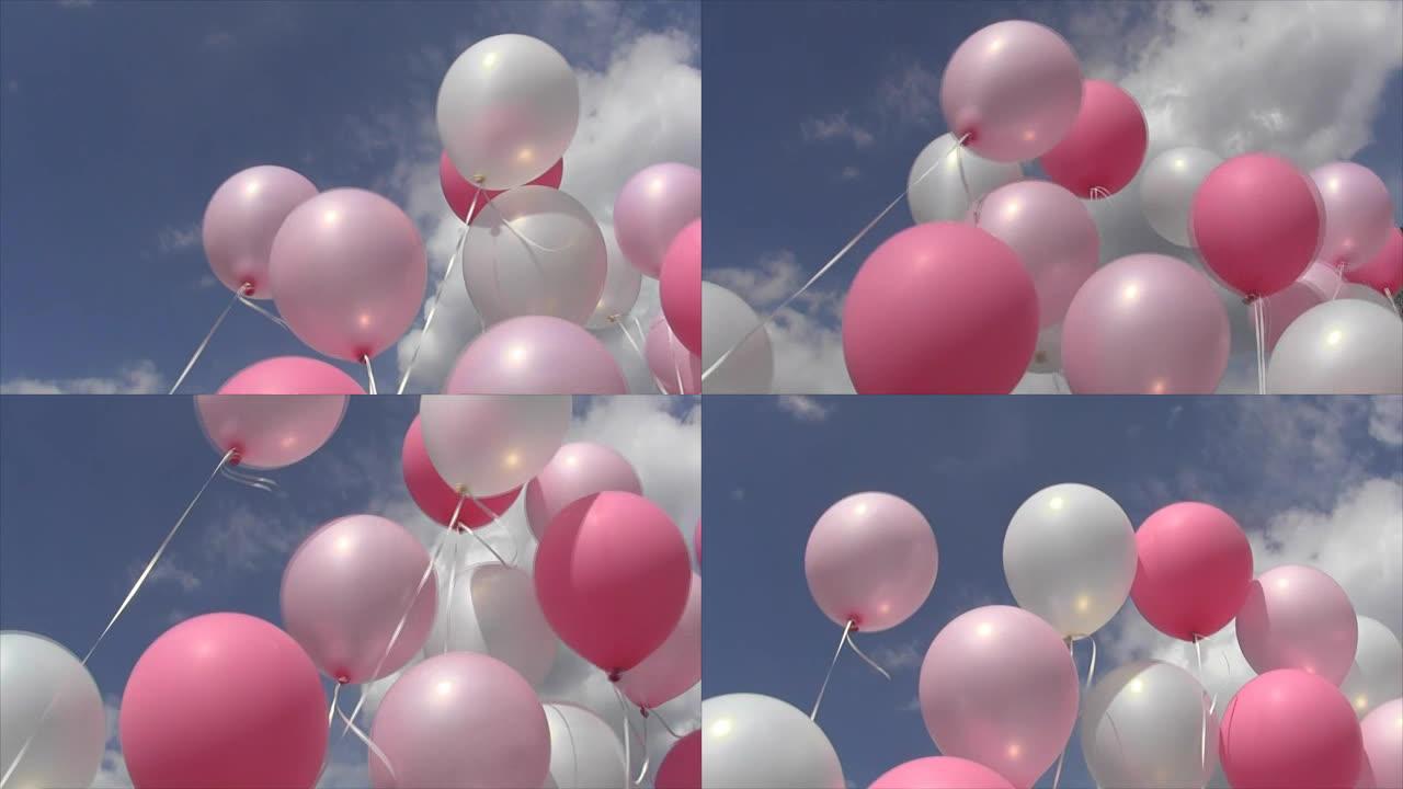 粉红色和白色的充气球的线在风的打击天空和云彩摆动
