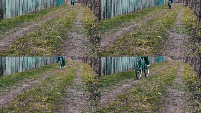 青少年骑着一辆老式蓝色自行车穿越村庄