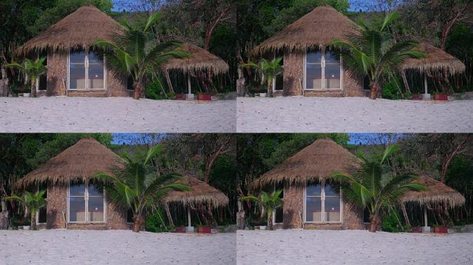 白色沙滩上有棕榈树的可爱的平房