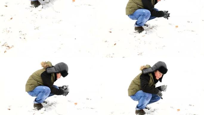快乐的孩子男孩在白雪皑皑的冬季公园玩雪
