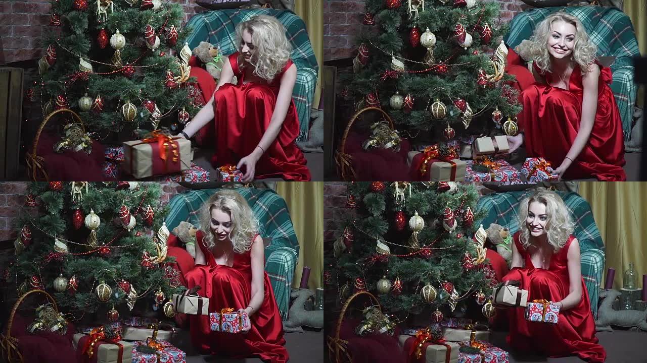 穿红裙子的女孩在圣诞树下堆放礼物