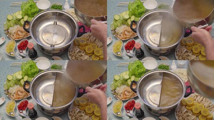 亚洲美食的概念。经验不足的厨师将汤倒入特殊的锅中
