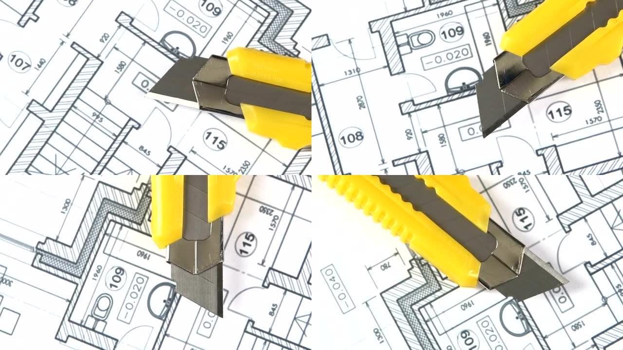建筑平面图上的黄色文具刀，旋转，特写