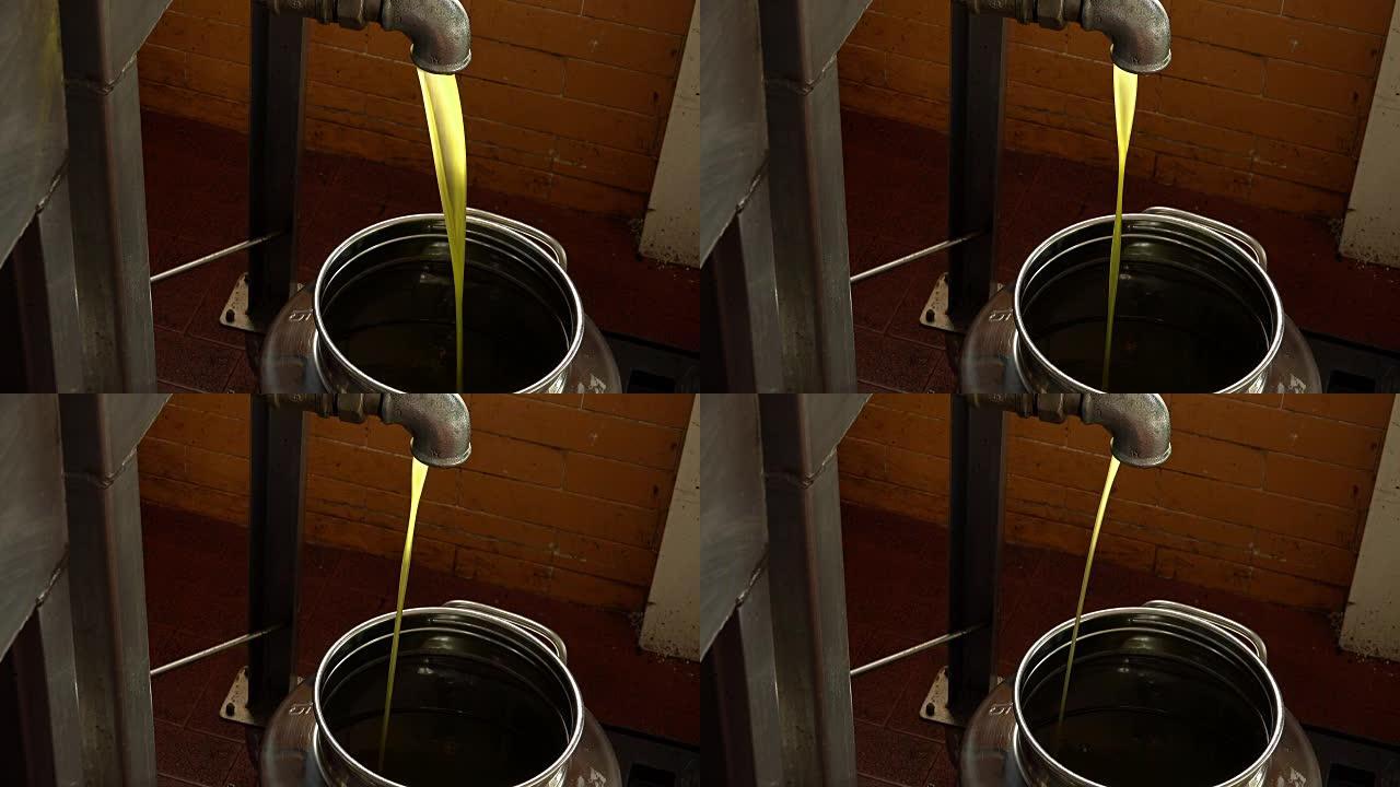 油厂-橄榄油生产: 落入不锈钢罐中的特级初榨油