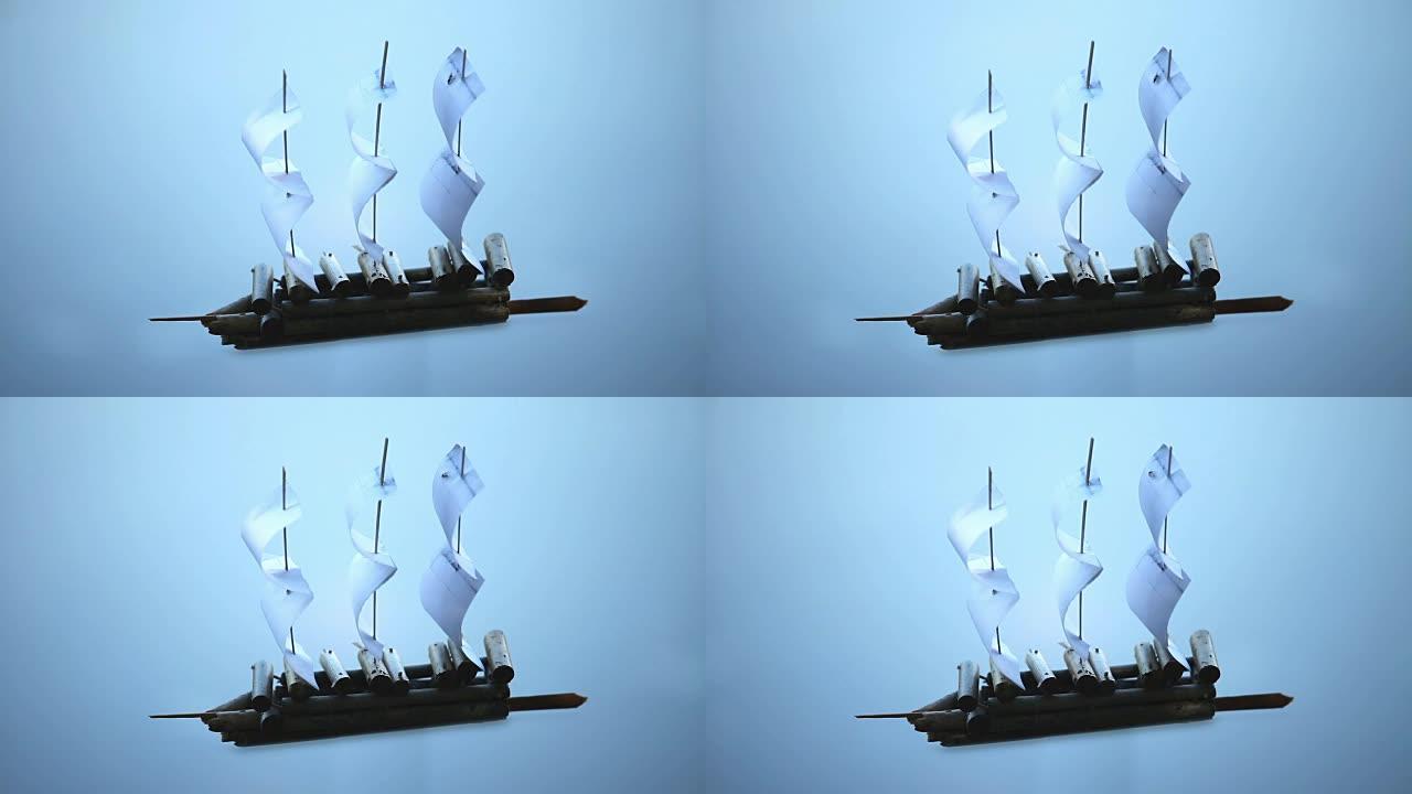 蓝色背景上的纸质帆船