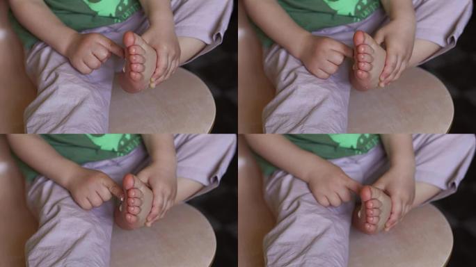 小男孩用奶油涂抹他的脚，特写。