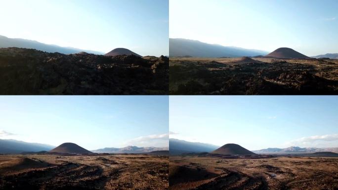 日落时缓慢揭示遥远的煤渣锥和火山平原