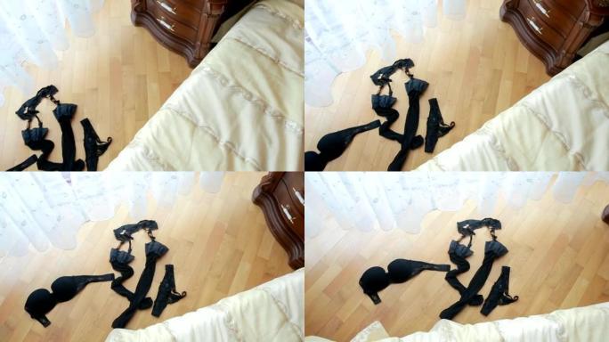 黑色性感内衣躺在床边的地板上
