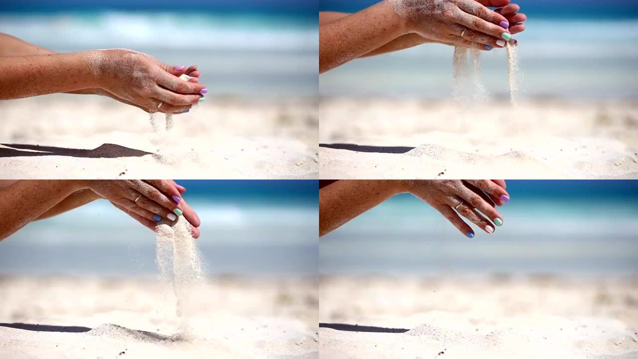 女人正在海滩上用手指倒沙子