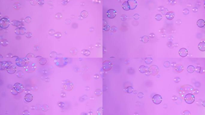 粉红色，背景，慢动作上的蓝色和透明肥皂泡