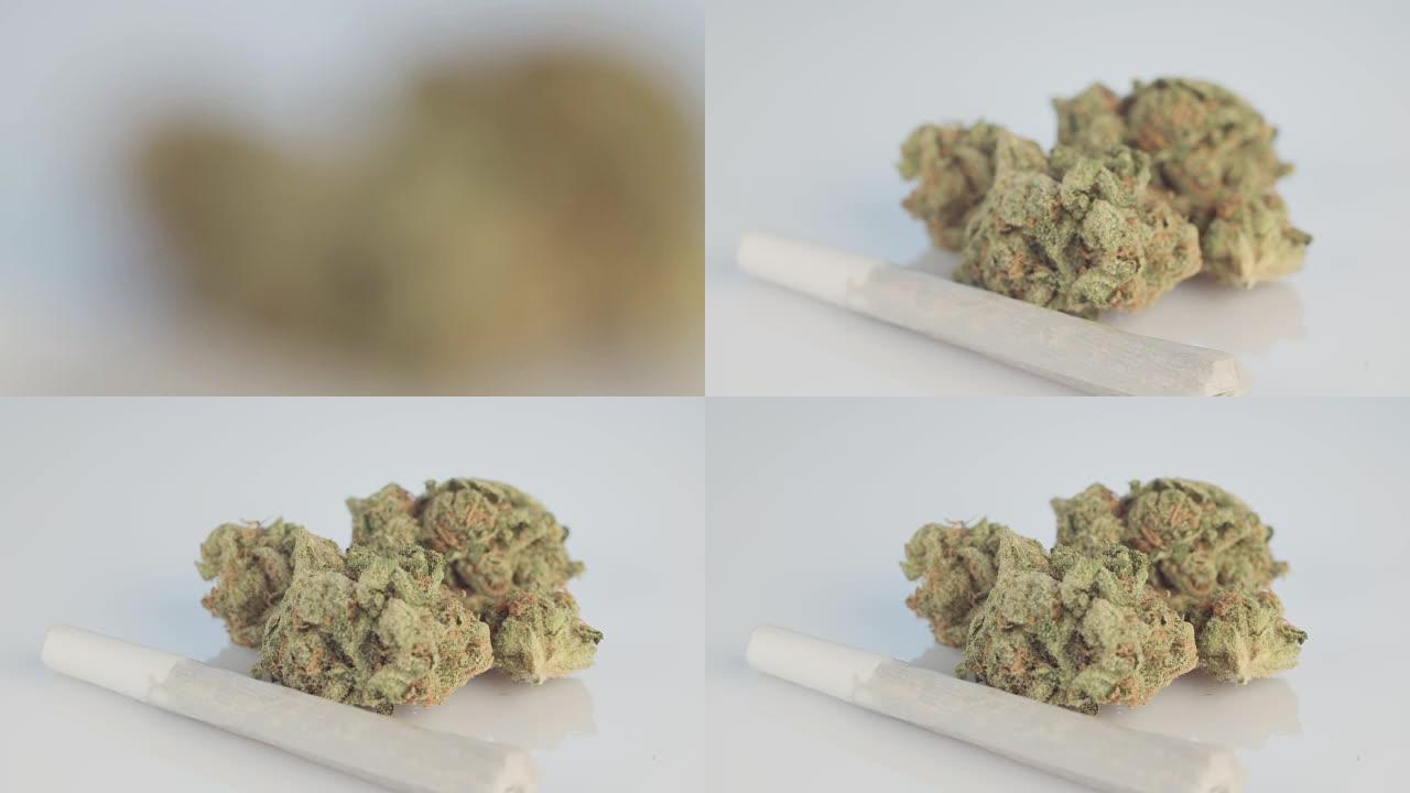 白色表面药用大麻花和关节的宏观拍摄
