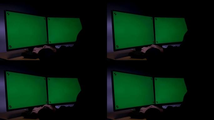 黑客使用计算机扩展绿色宽屏监视器，在黑暗的房间里带有运动跟踪标记，环境声音未来派技术和网络犯罪概念黑
