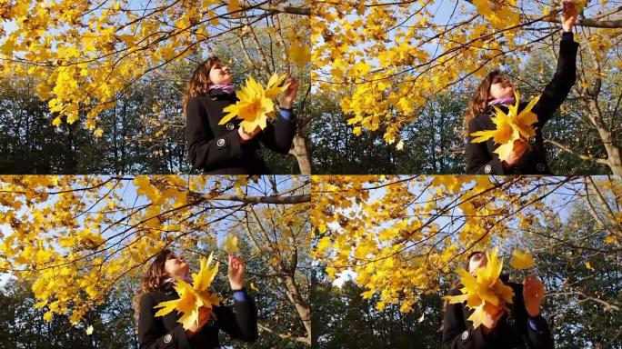 在秋天的公园里，一个女孩从树枝上扔下黄叶