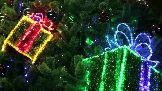 装饰圣诞树，带有闪烁的礼品盒和发光的灯