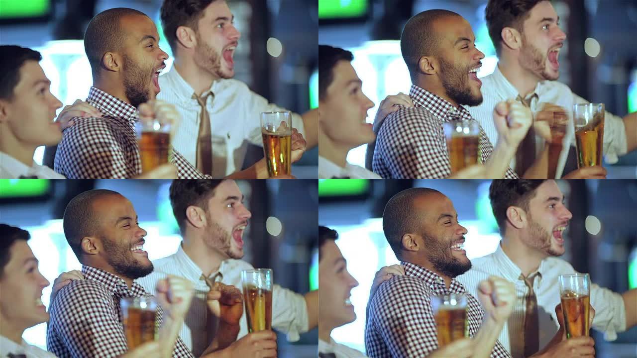 男子球迷挥舞双手，在电视上看足球，喝啤酒