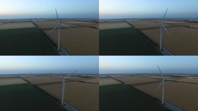 黄昏时有风车和农田的景观。航空测量