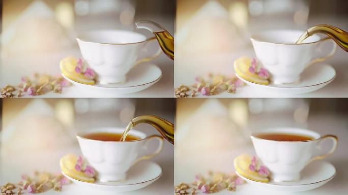 将茶倒入带有柠檬和玫瑰的漂亮白色杯子中