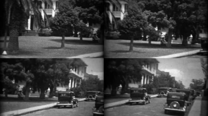 1934: 南方豪宅之家经典20世纪30年代汽车停在街上。