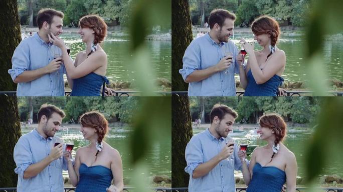 湖边的浪漫之吻: 男人和女人在公园接吻