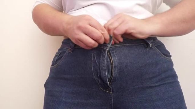 超重的女人穿小牛仔裤。