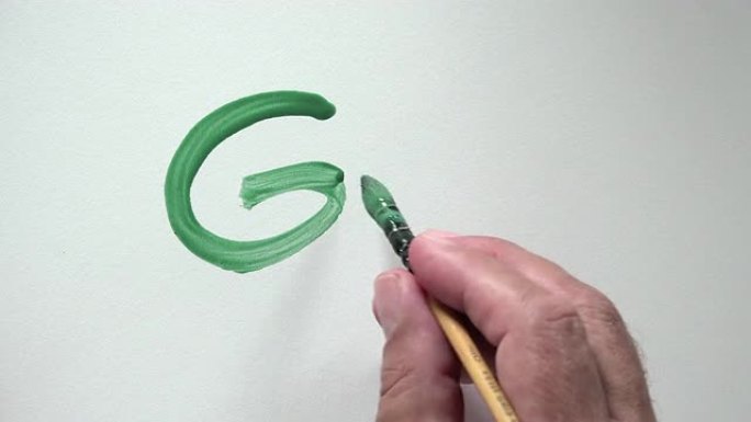 人类用绿色水粉手写单词 “走”