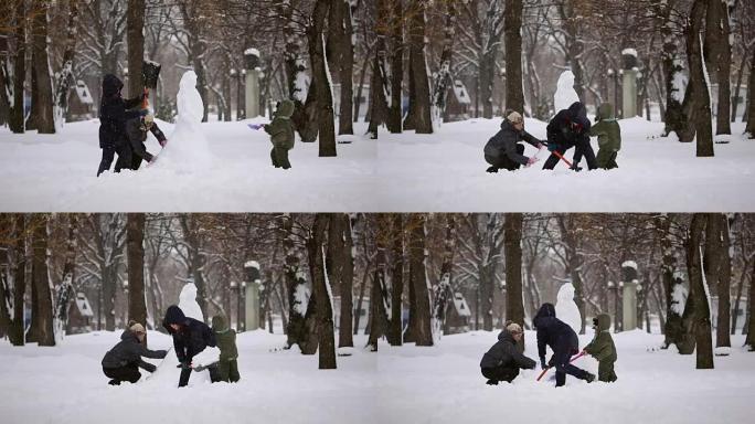 幸福家庭从雪中雕刻雪人