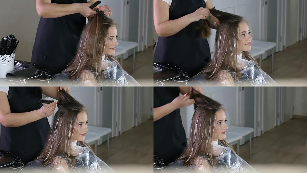 专业美发师，发型师使用发夹固定头发为少女准备发型