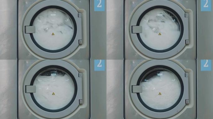 公共洗衣房的一台大型洗衣机，带旋转滚筒